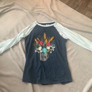 A girls  10/12  shirt has flowers on it and the sleeves are half sleeves